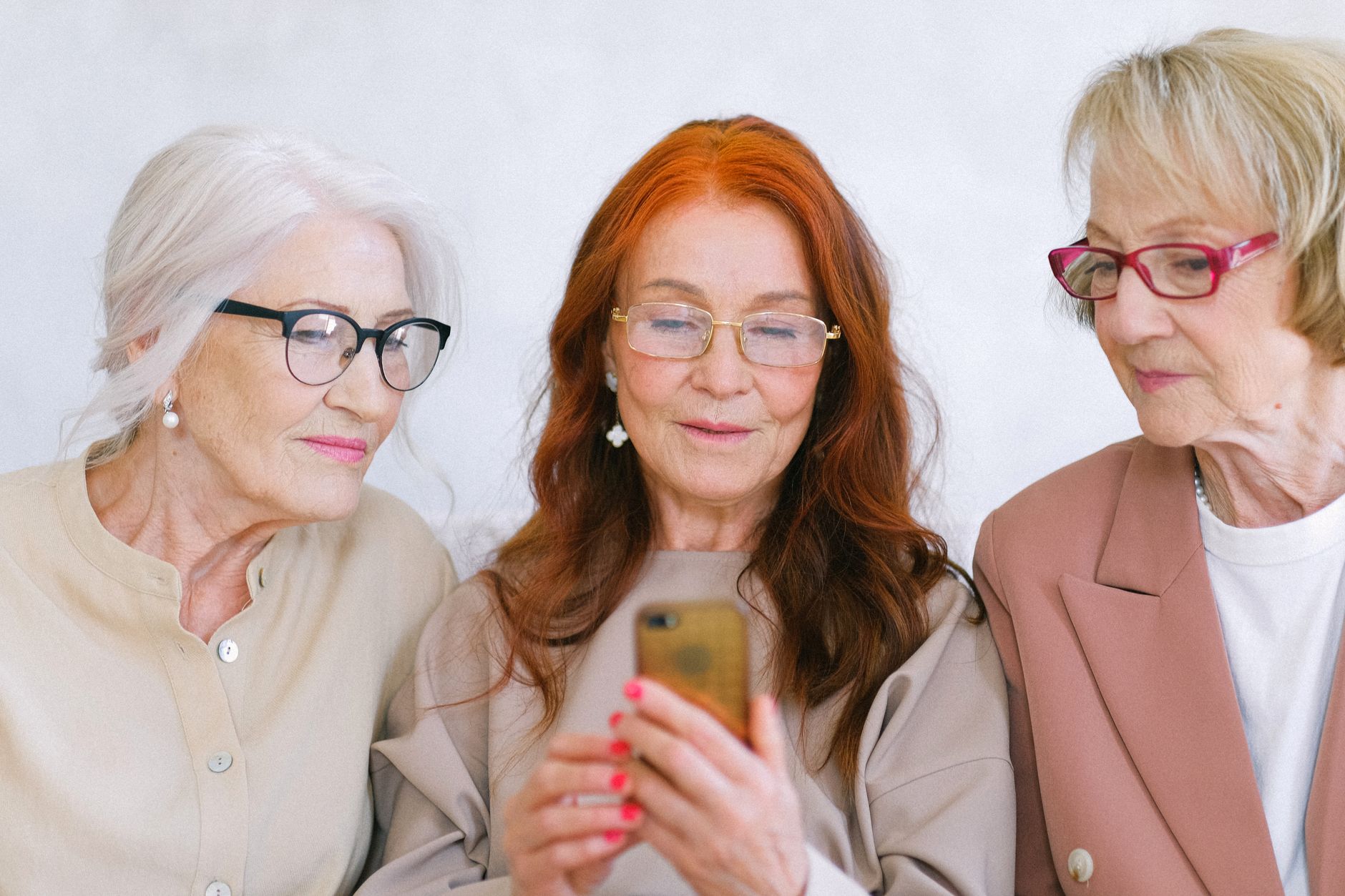 Older adult reviews recovered photo thumbnails on an Android phone screen